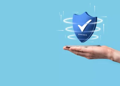 Hand holding a shield to represent fraud prevention and security